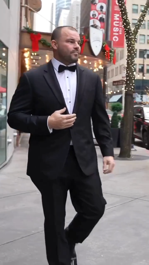 Travis Bagent, World Champion Arm wrestler, in a Balani Custom black tuxedo.